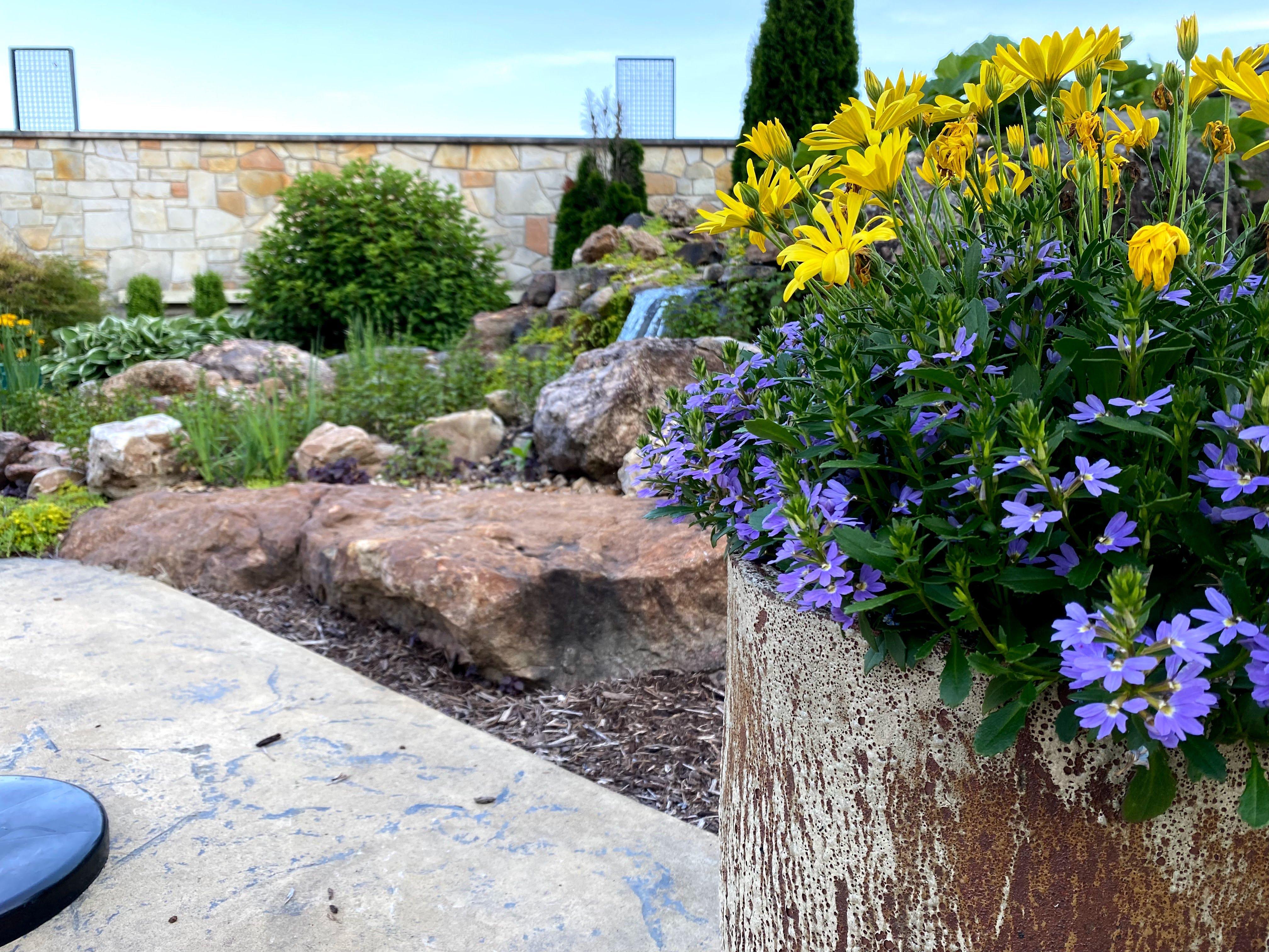 Custom stone wall waterfall and planter installation at a Missouri winery